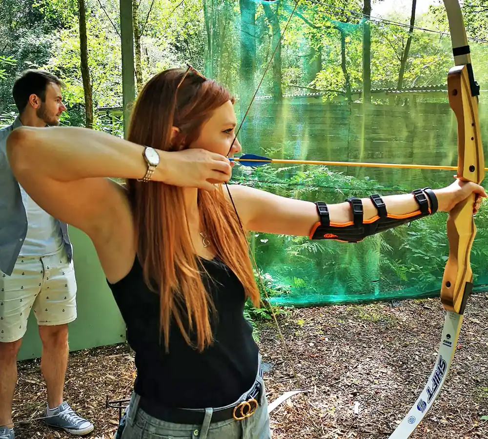 Excited lady shooting a recurve bow at Adventure Now