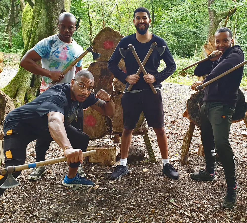 Group of fun guys posing with axes after their axe throwing session