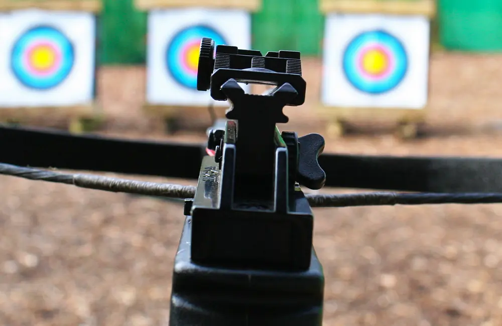 View down crossbow iron sights, with target in the background at Adventure Now Manchester