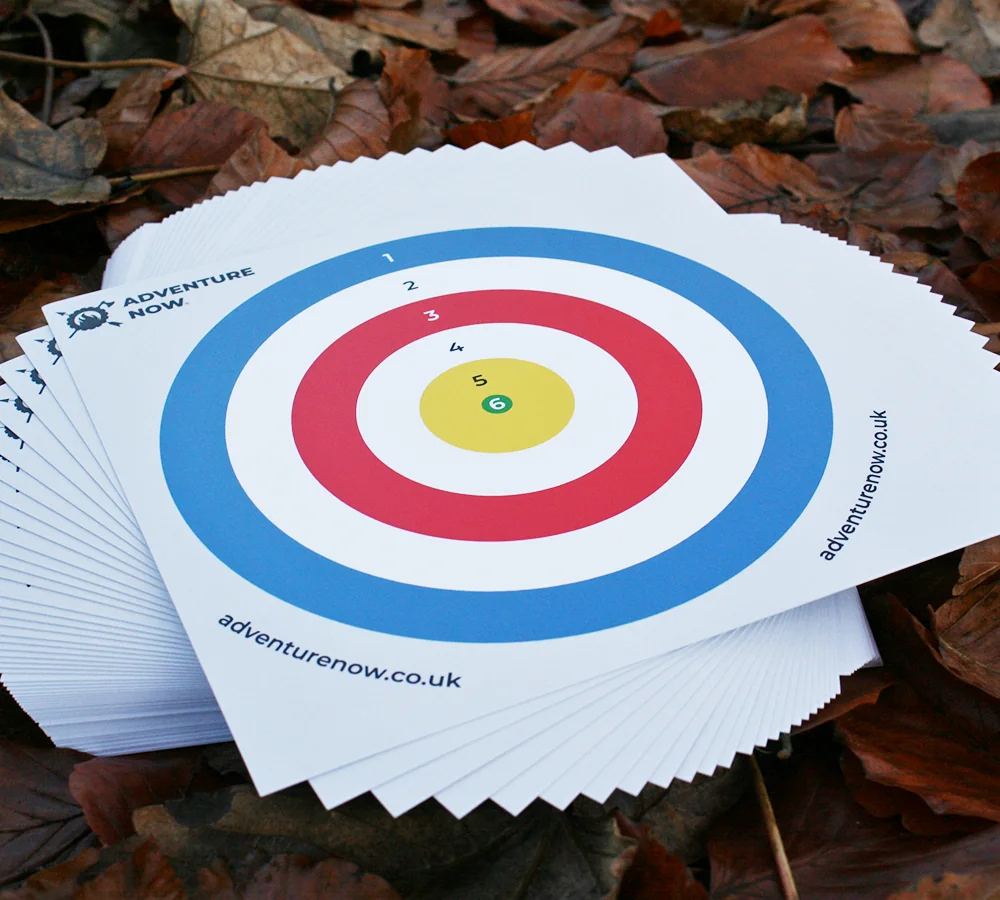 Stack of Adventure Now branded air pistol target scorecards