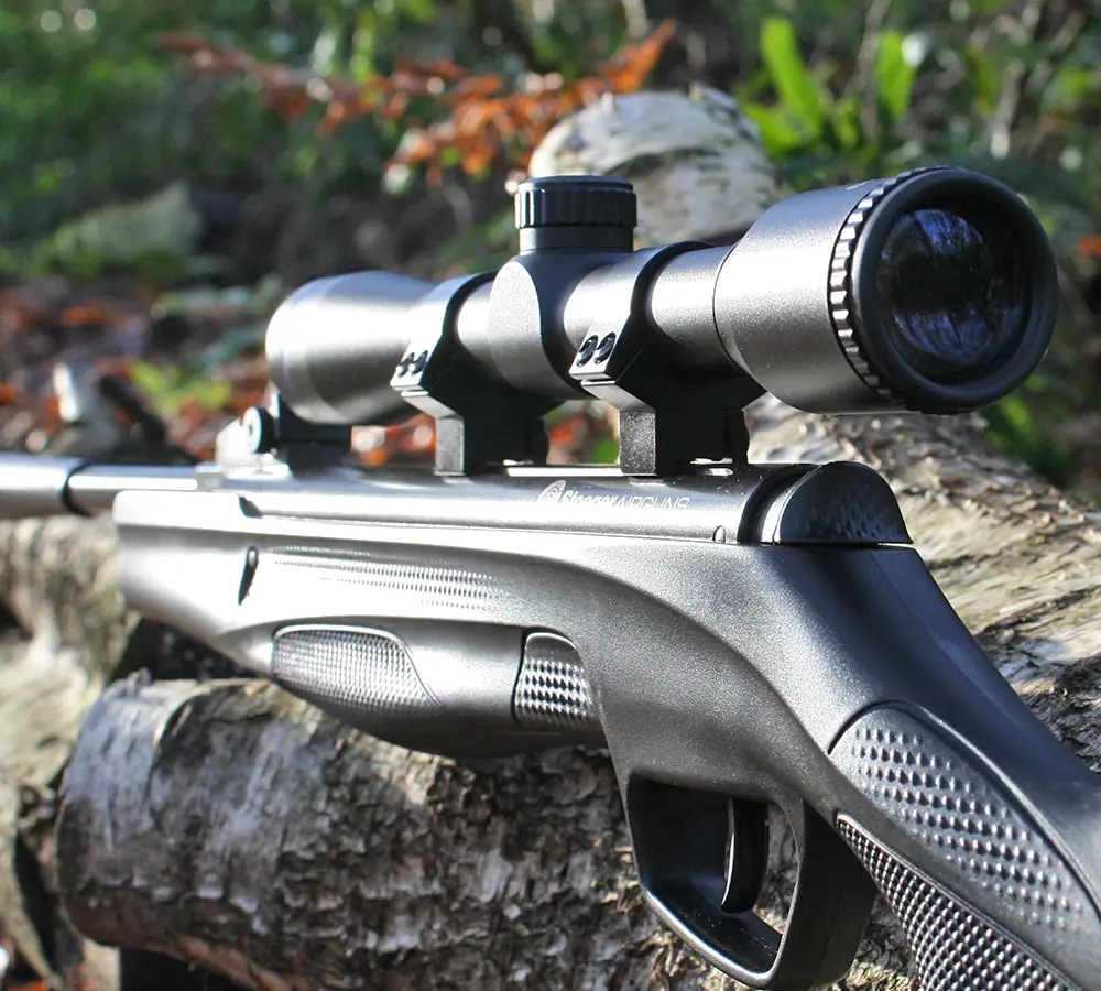 Closeup photo of an air rifle with a telescopic scope