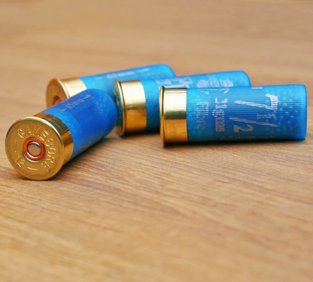 Closeup photo of four blue shogun shells, showing the brass casing