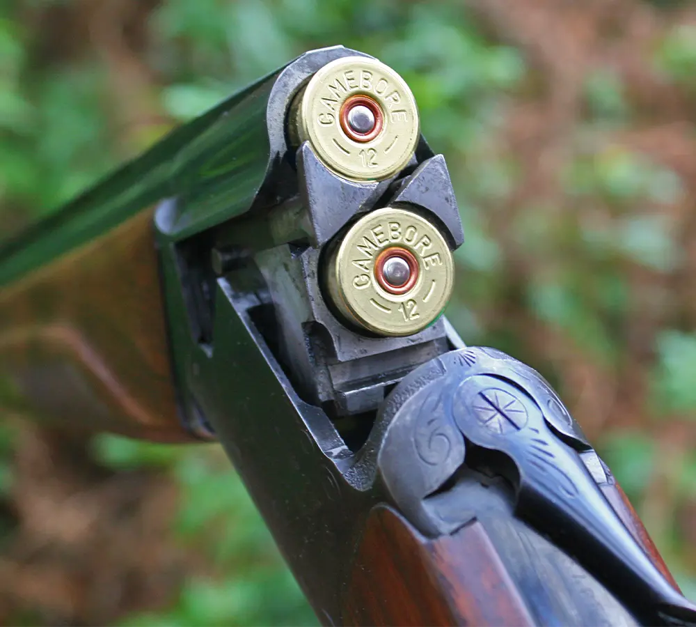 Closeup photo of a 12 gauge over under shotgun loaded with two shotgun cartridges