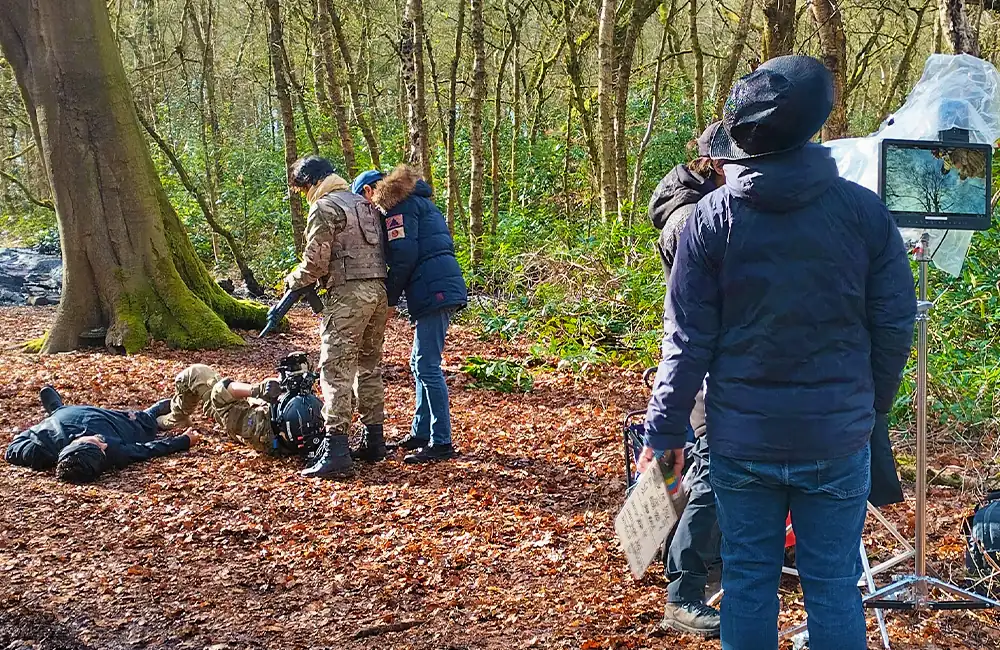 Outdoor combat scene filming with director monitor and helmet camera