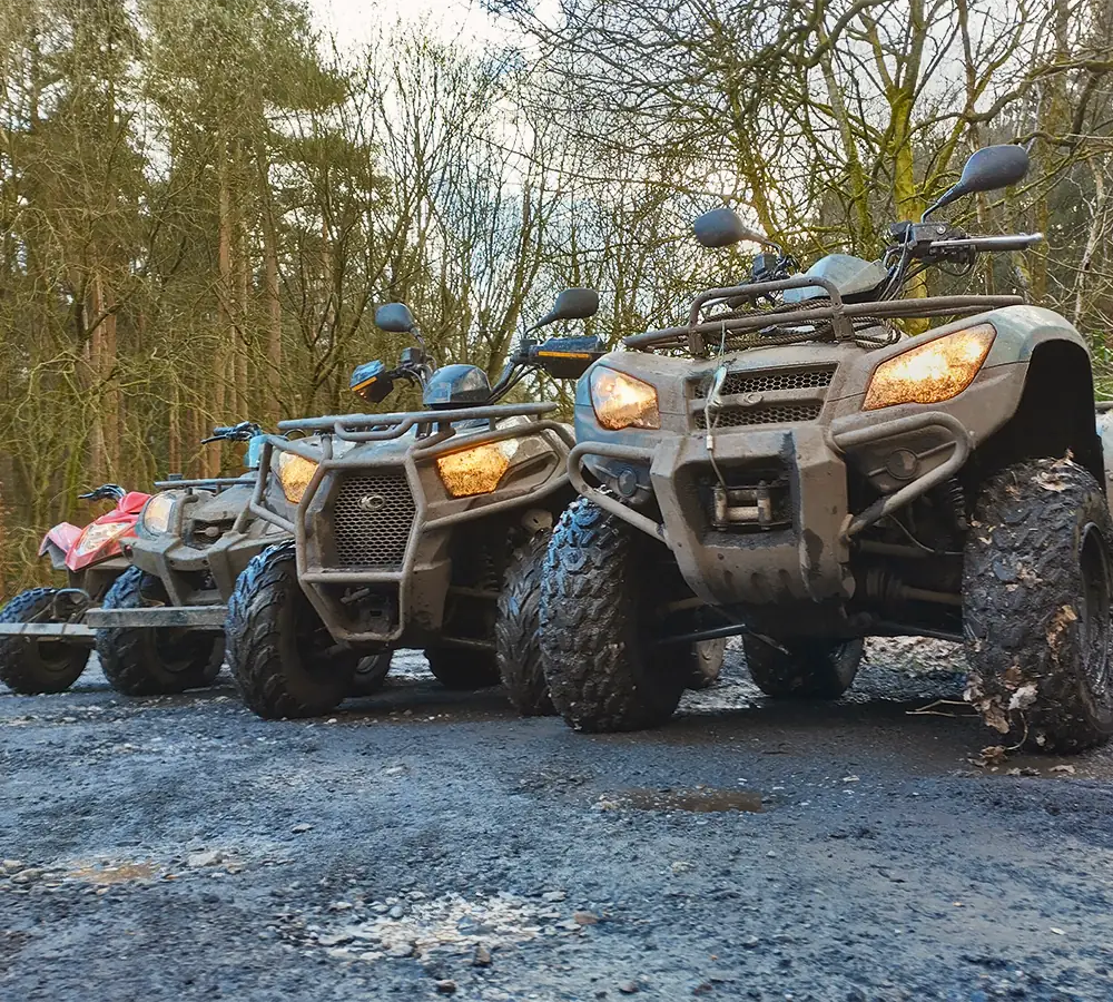 Line of four ATVs for photography in manchester in a woodland setting