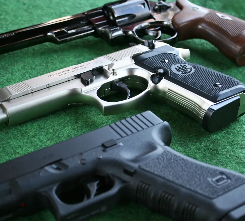 Closeup of three pistols for filming and photography hire