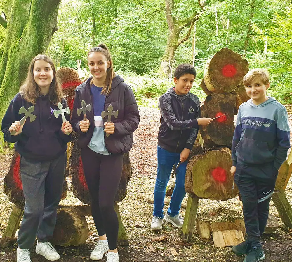 Family group stood holding throwing knives at Adventure Now Manchester