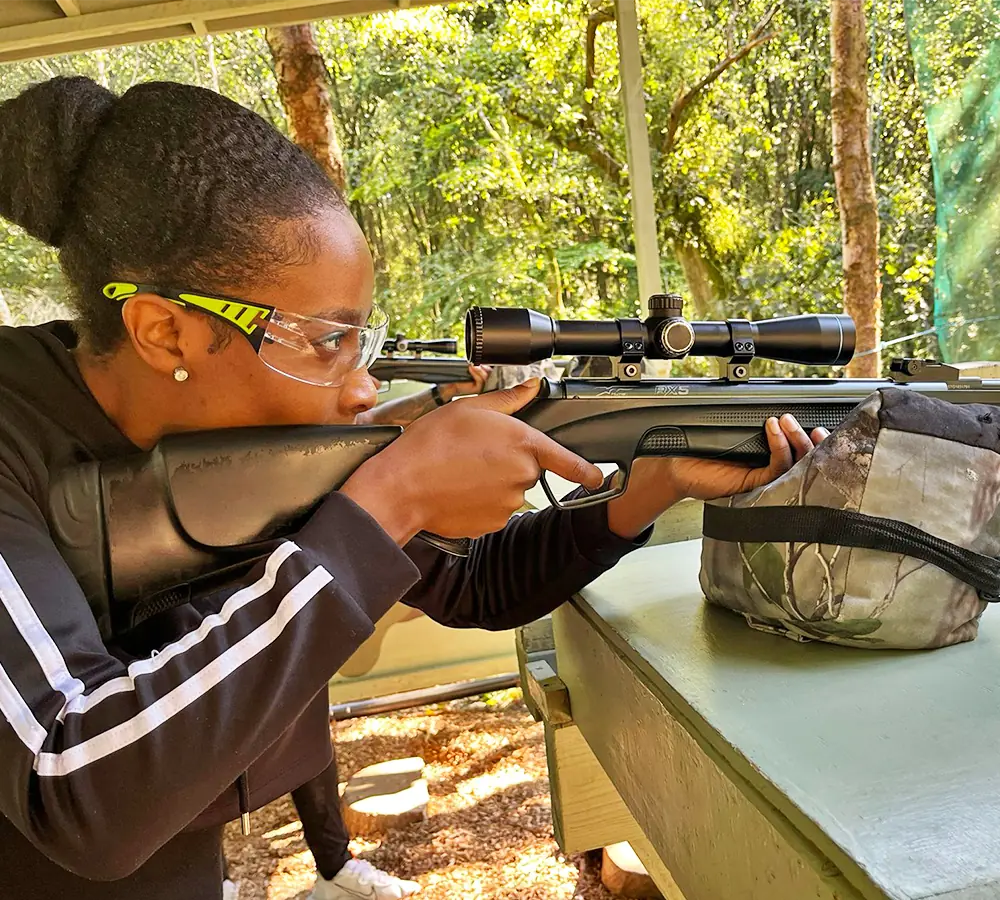 Excited lady shooting an air rifle on her hen party