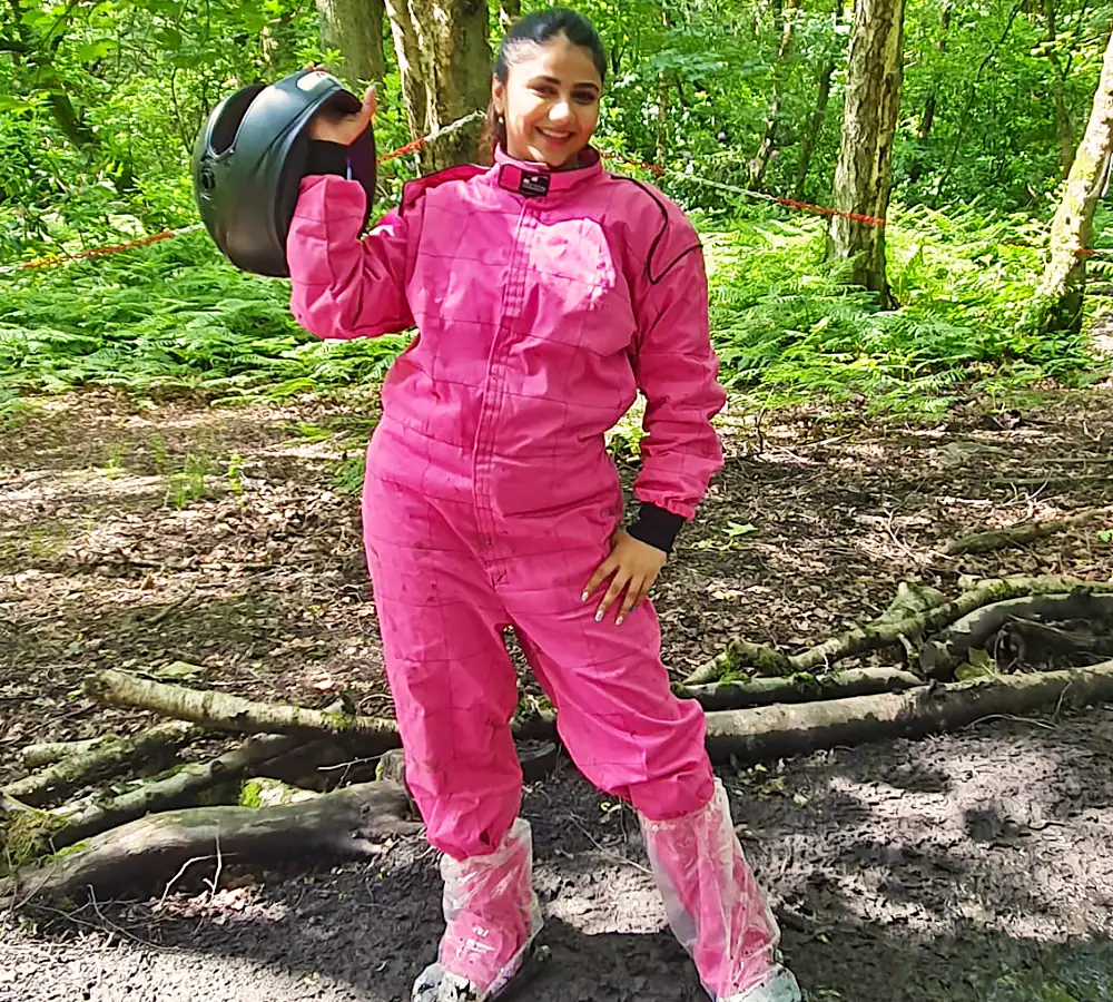 Bride on her hen do before going quad biking. Dressed in pink and holding crash helmet