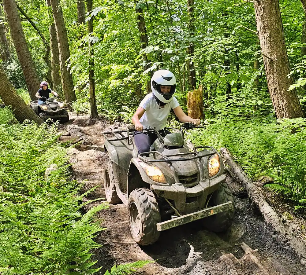 Person driving a quad bike on an off-roading trail in Manchester